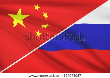 Flags of China and Russian Federation blowing in the wind. Part of a series.