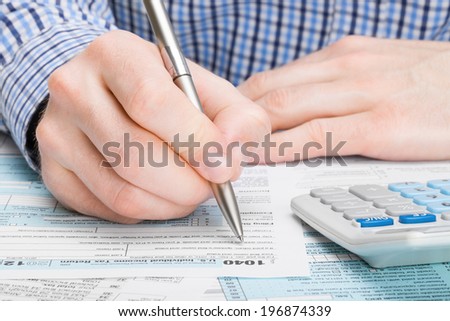 Tax Form 1040 - male filling out tax form