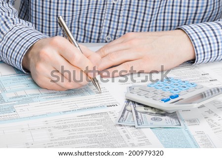 Male filling out 1040 US Tax Form