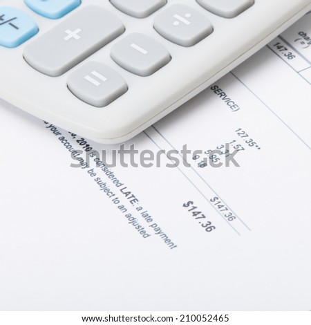 Calculator over utility bill under it - 1 to 1 ratio