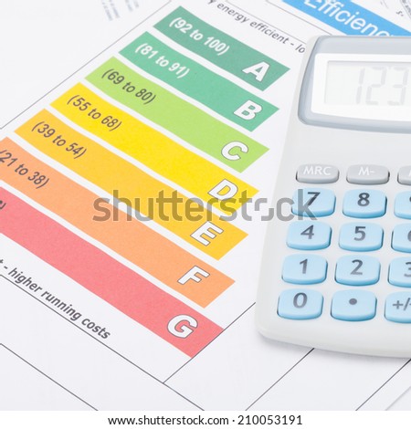 Calculator over energy efficiency chart - studio shot - 1 to 1 ratio