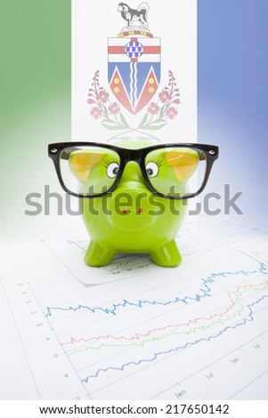 Piggy bank with Canadian province flag on background - Yukon