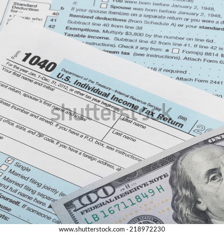 US Tax Form 1040 with 100 dollars banknote above it - 1 to 1 ratio