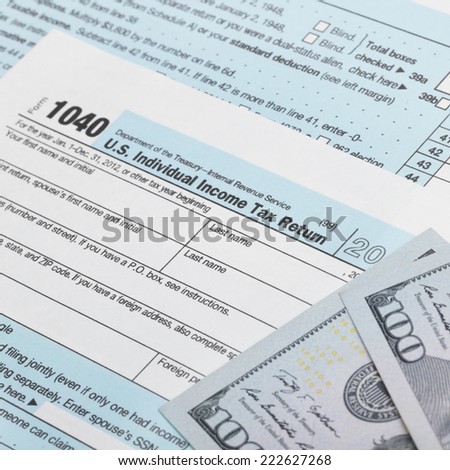 US Tax Form 1040 with 100 dollars bills - 1 to 1 ratio