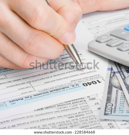 Male filling out 1040 Tax Form