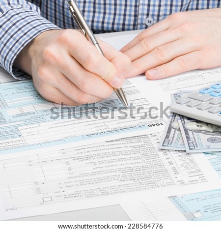 Male filling out 1040 USA Tax Form
