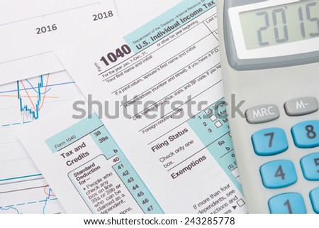 1040 US Tax Form with calculator next to it