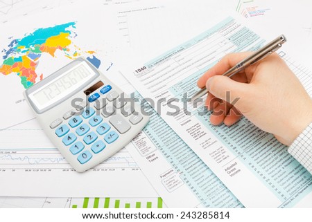 Man filling out 1040 US Tax Form