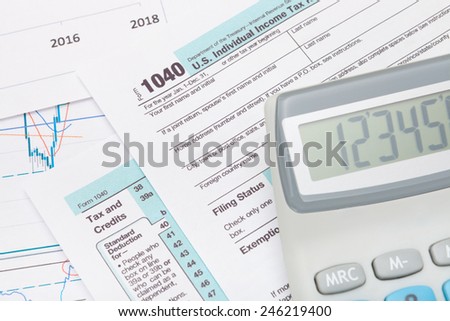 Calculator over US 1040 Tax Form