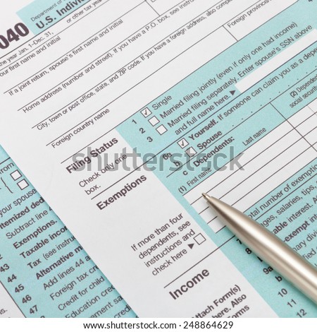 US 1040 Tax Form and silver ball pen - studio shot