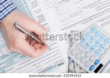 Taxpayer filling out USA 1040 Tax Form