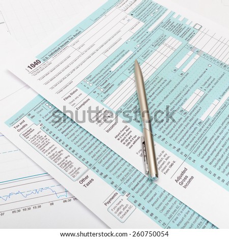 US 1040 Tax Form and silver ball pen over it - studio shot