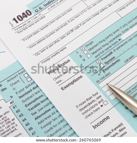 US 1040 Tax Form and silver ball pen - studio shot