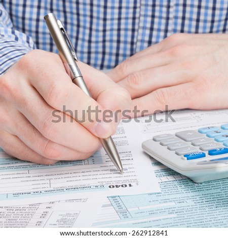Taxpayer filling out 1040 Tax Form
