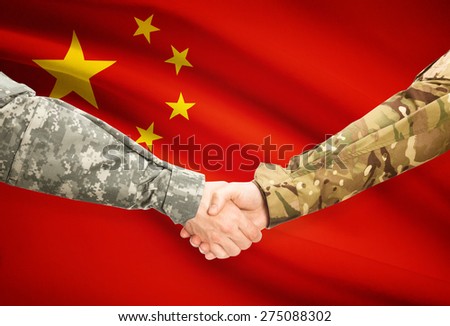Soldiers shaking hands with flag on background - China