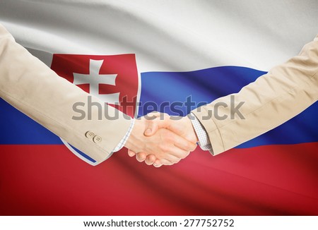 Businessmen shaking hands with flag on background - Slovakia