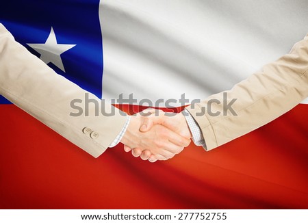 Businessmen shaking hands with flag on background - Chile