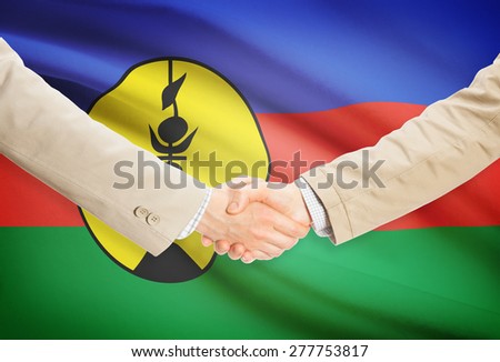 Businessmen shaking hands with flag on background - New Caledonia