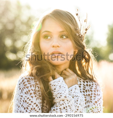 Beautiful lady model in open field at sunrise - outdoors shot