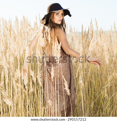 Beautiful model making her way through tallgrass - outdoors shot