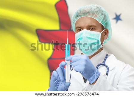 Doctor with syringe in hands and Canadian province flag on background - Nunavut