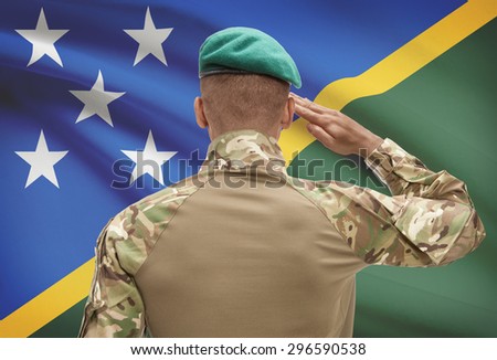 Dark-skinned soldier in hat facing national flag series - Solomon Islands
