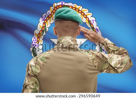 Dark-skinned soldier in hat facing national flag series - Northern Marianas