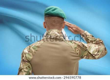 Dark-skinned soldier in hat facing national flag series - Saint Lucia