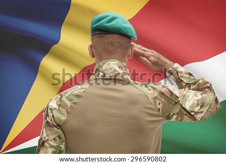 Dark-skinned soldier in hat facing national flag series - Seychelles