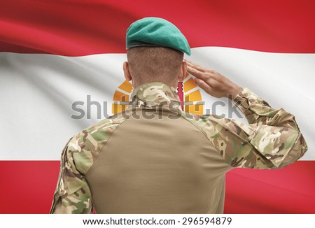 Dark-skinned soldier in hat facing national flag series - French Polynesia