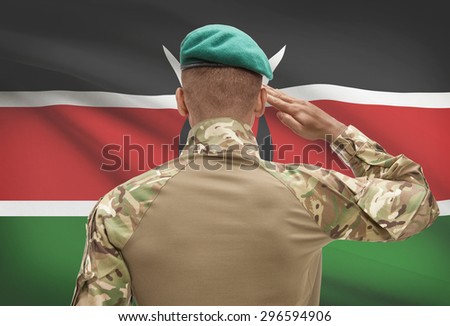 Dark-skinned soldier in hat facing national flag series - Kenya