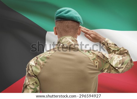 Dark-skinned soldier in hat facing national flag series - Kuwait