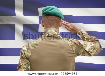 Dark-skinned soldier in hat facing national flag series - Greece
