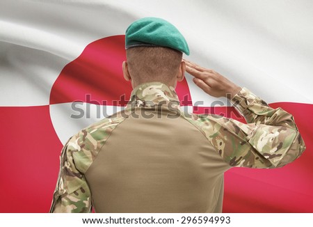 Dark-skinned soldier in hat facing national flag series - Greenland