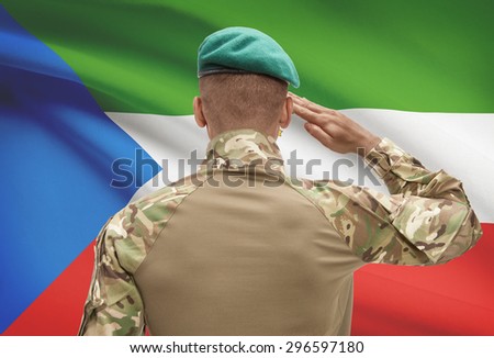 Dark-skinned soldier in hat facing national flag series - Equatorial Guinea