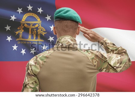 Dark-skinned soldier in hat facing US state flag series - Georgia