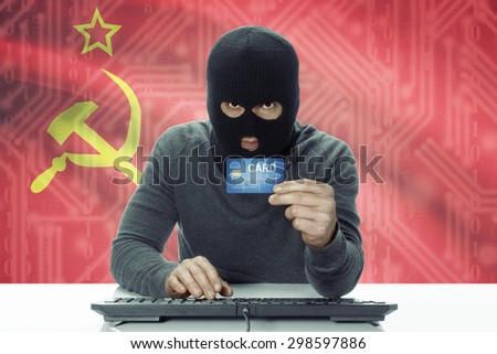 Dark-skinned hacker with credit card and flag on background - USSR - Soviet Union