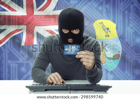 Dark-skinned hacker with credit card and flag on background - Saint Helena