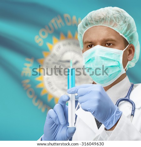 Doctor with syringe in hands and USA states flags on background series - South Dakota