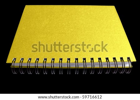 Gold notebook spiral isolated on black