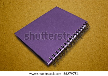 Purple Notebook On Brown Surface