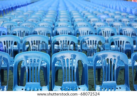 Rows of blue color chairs in an event field