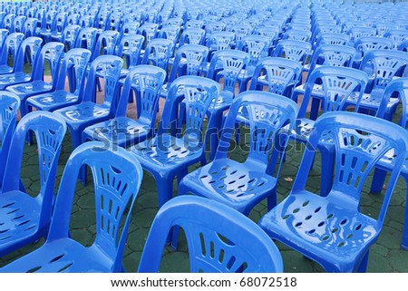 Rows of blue color chairs in an event field