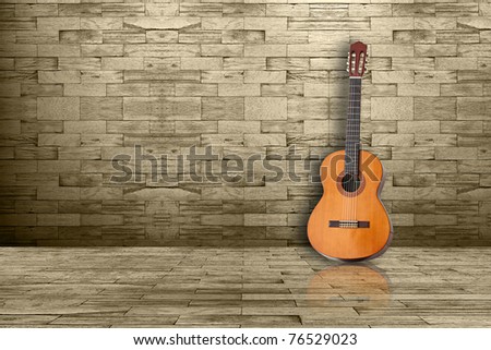 Acoustic guitar in a room wood wall