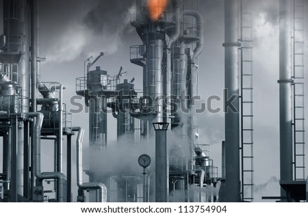 oil, gas and fuel installation, burning safety flames in middle tower, blue toning concept
