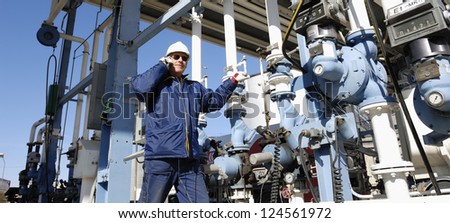 main oil and fuel station inside large oil and gas refinery, worker talking in phone