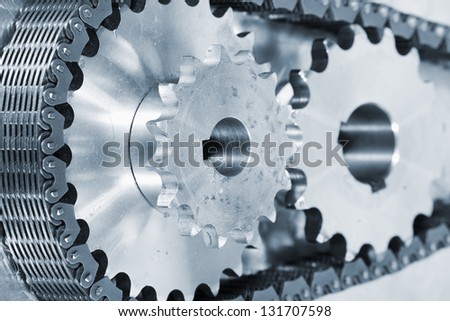 industry gears and cogs powered by large timing chain, blue toning concept