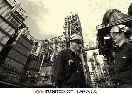 oil and gas workers inside large chemical refinery industry