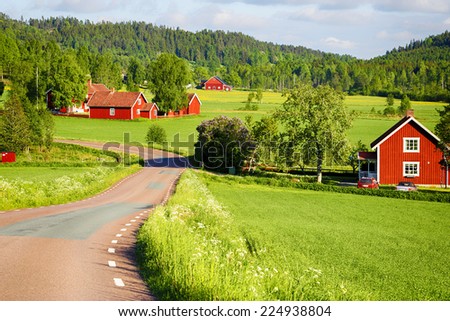 old red farm houses set in a rural landscape and nature