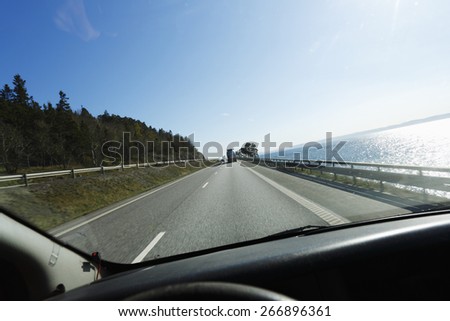 car driving a scenic highway route, seen from drivers perspective, vantage point.
